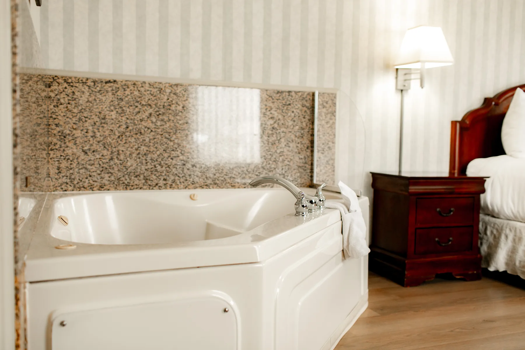 Jacuzzi tub beside a king bed