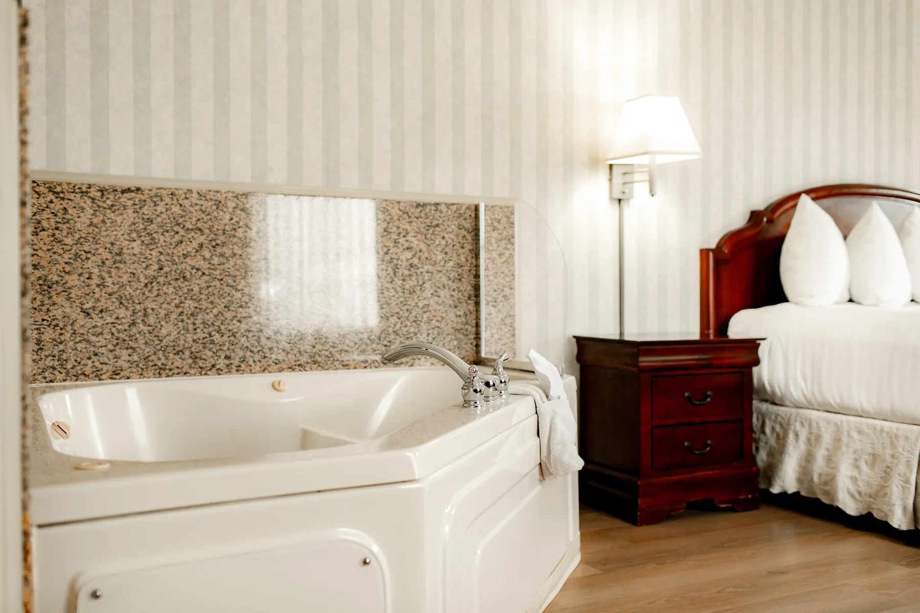 Jacuzzi tub with bed and nightstand