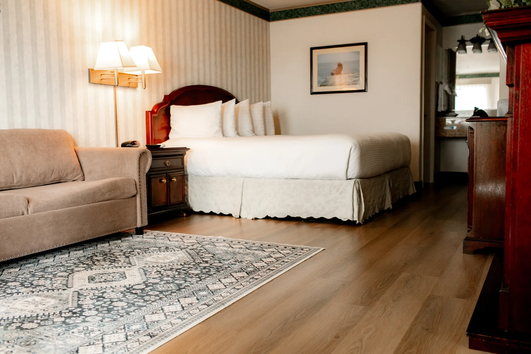Fireplace suite with sofa, rug, and king bed