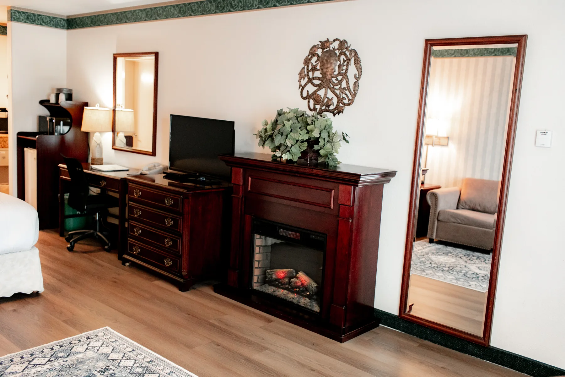 Room dresser, fireplace, and full mirror