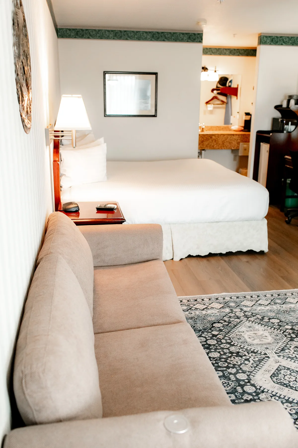 Vertical view of sofa and bed in a suite