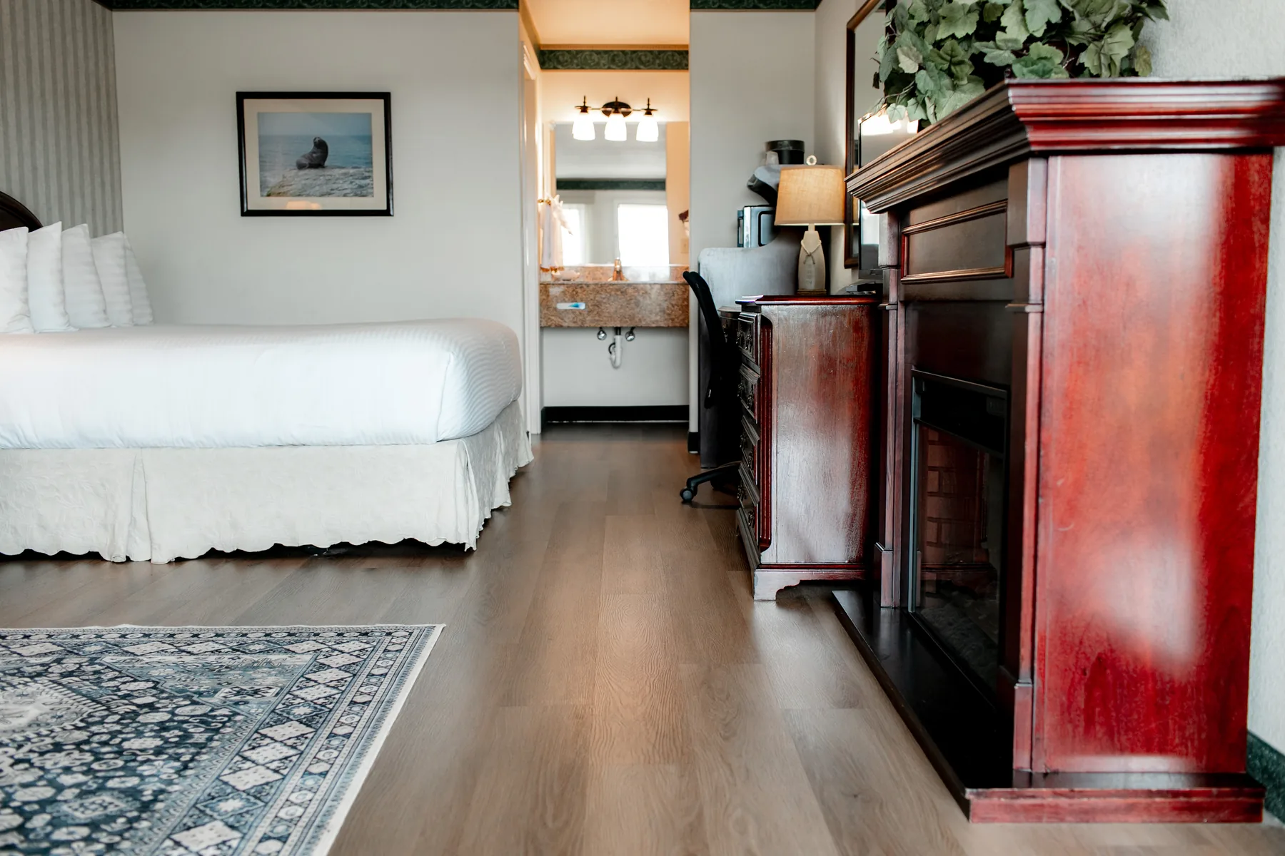 Suite bedroom with fireplace cabinet and bed