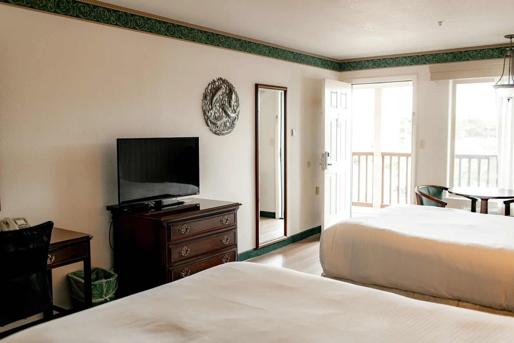 Two queen room with television and dresser